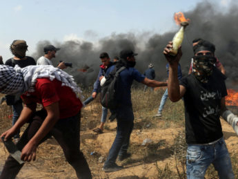 Masked Palestinian holding Molotov cocktail.