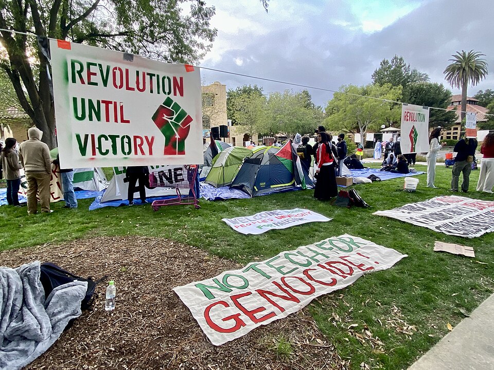 stanford protest sign says revolution until victory